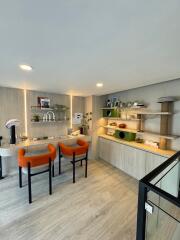 Modern living room with orange chairs and wooden accents