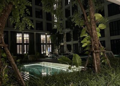 Outdoor building view with pool and greenery