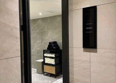 Modern public bathroom entrance with folded towels