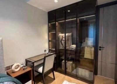 Modern bedroom with a study desk and a glass-door wardrobe