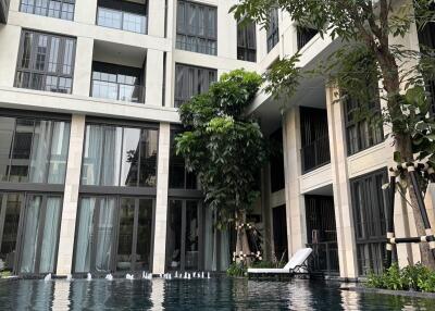 Outdoor pool area in front of a modern residential building