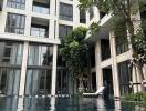 Outdoor pool area in front of a modern residential building