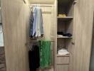 Bedroom closet with hanging clothes and shelves