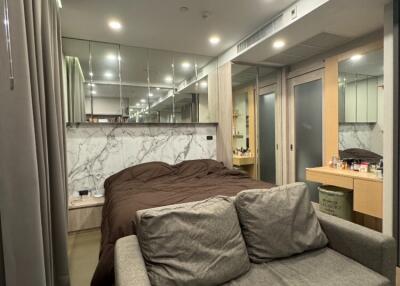 Modern studio apartment with bed and seating area