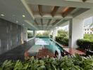 Modern outdoor pool area with seating and greenery