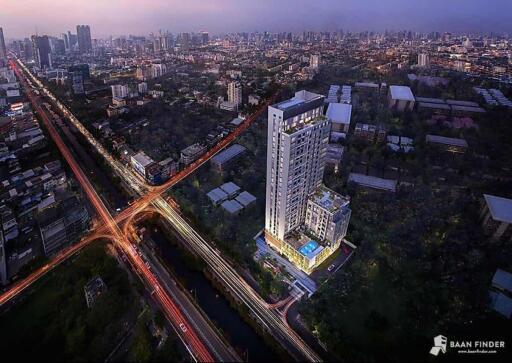 Aerial view of a high-rise building in a cityscape during dusk