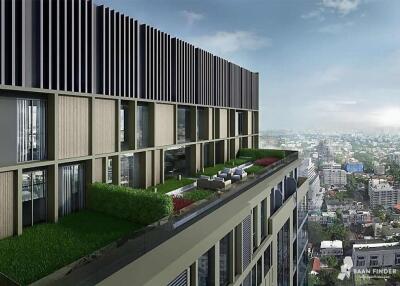 Modern high-rise building with green rooftop and city view