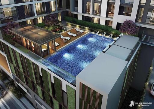 Rooftop swimming pool with lounge chairs and greenery