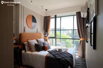 Modern bedroom with large window and stylish decor