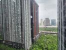 View of high-rise residential buildings with a green area