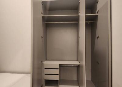 Open wardrobe with hanging rod and drawers