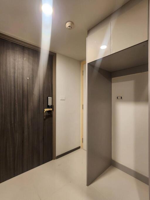 Modern hallway with wooden door and fitted storage