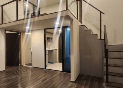 Loft style living area with modern fixtures and dark wooden flooring