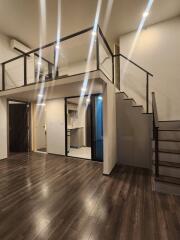 Loft style living area with modern fixtures and dark wooden flooring