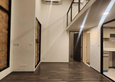 Spacious main living area with high ceilings and wooden flooring