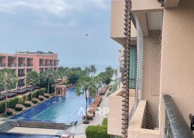 View from balcony overlooking pool and greenery