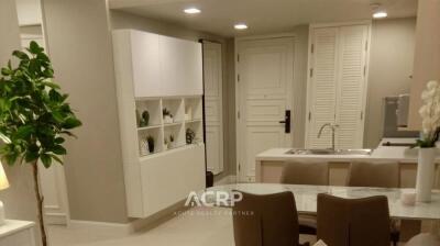 Modern living area with dining table and built-in shelves