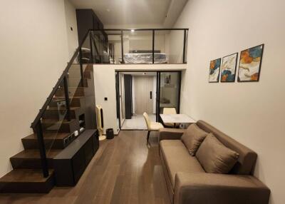 Modern living area with loft bedroom and dining space