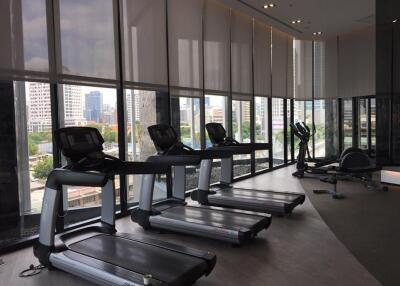 Modern fitness center with treadmills and city view