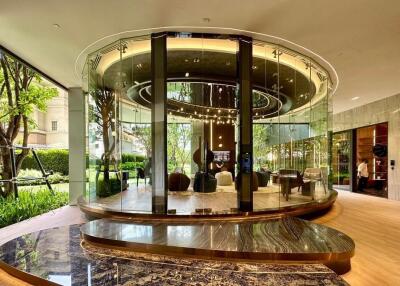 Elegant circular glass-walled room with modern furnishings