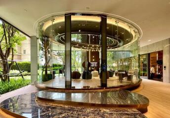 Elegant circular glass-walled room with modern furnishings