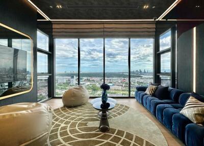 Elegant living room with large windows offering a panoramic city view