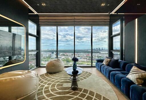 Elegant living room with large windows offering a panoramic city view