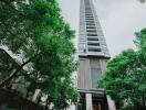 High-rise apartment building exterior with trees