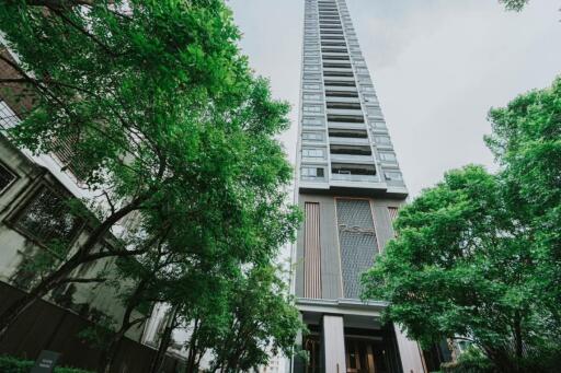 High-rise apartment building exterior with trees