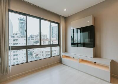 Modern living room with large windows and built-in entertainment unit