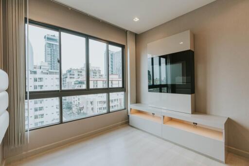 Modern living room with large windows and built-in entertainment unit