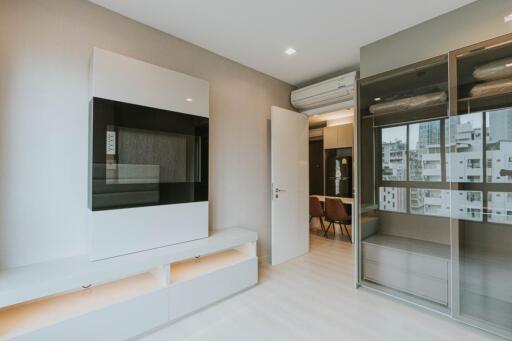 Modern living room with built-in cabinets and city view