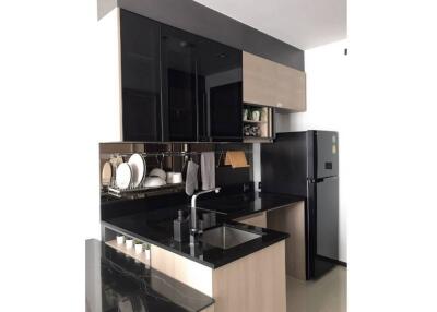 Modern kitchen with black countertops and cabinets