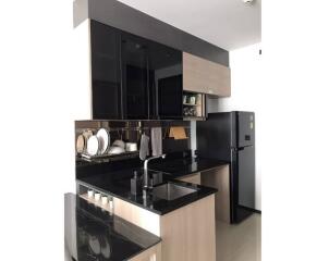 Modern kitchen with black countertops and cabinets