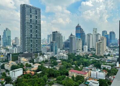 View of modern city skyline with high-rise buildings and greenery