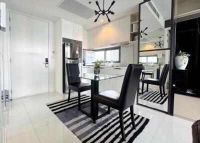 Modern dining area with glass table and black chairs