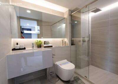 Modern bathroom with glass shower and bidet toilet