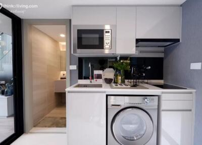 Modern kitchen with high-end appliances including washing machine