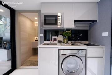 Modern kitchen with high-end appliances including washing machine