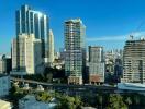 City skyline with various high-rise buildings and infrastructure