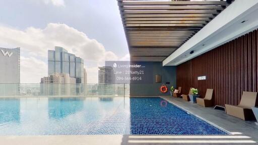 modern high-rise building with rooftop pool and lounge area