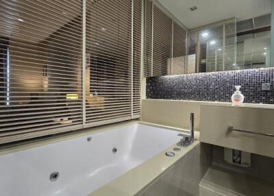 Modern bathroom with a bathtub and stylish tiles