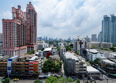 Cityscape view of residential and commercial buildings with high-rise structures in the background