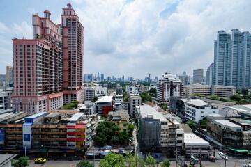 Cityscape view of residential and commercial buildings with high-rise structures in the background