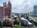 Cityscape view of residential and commercial buildings with high-rise structures in the background