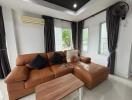 Living room with brown leather sectional sofa and wooden coffee table