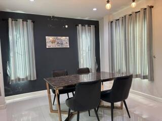 Modern dining room with marble table and chairs