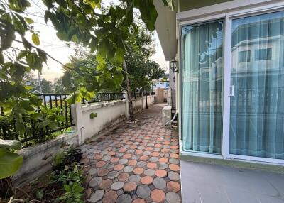 Side view of property with walking path and garden