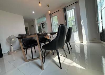 Modern dining area with sleek furniture and large windows