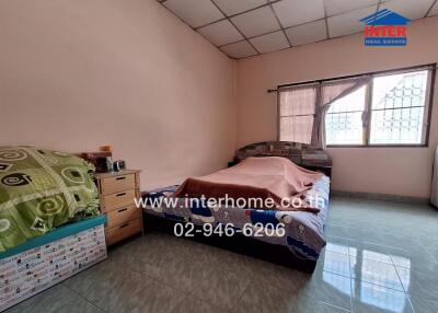 Bedroom with bed, nightstand, and window